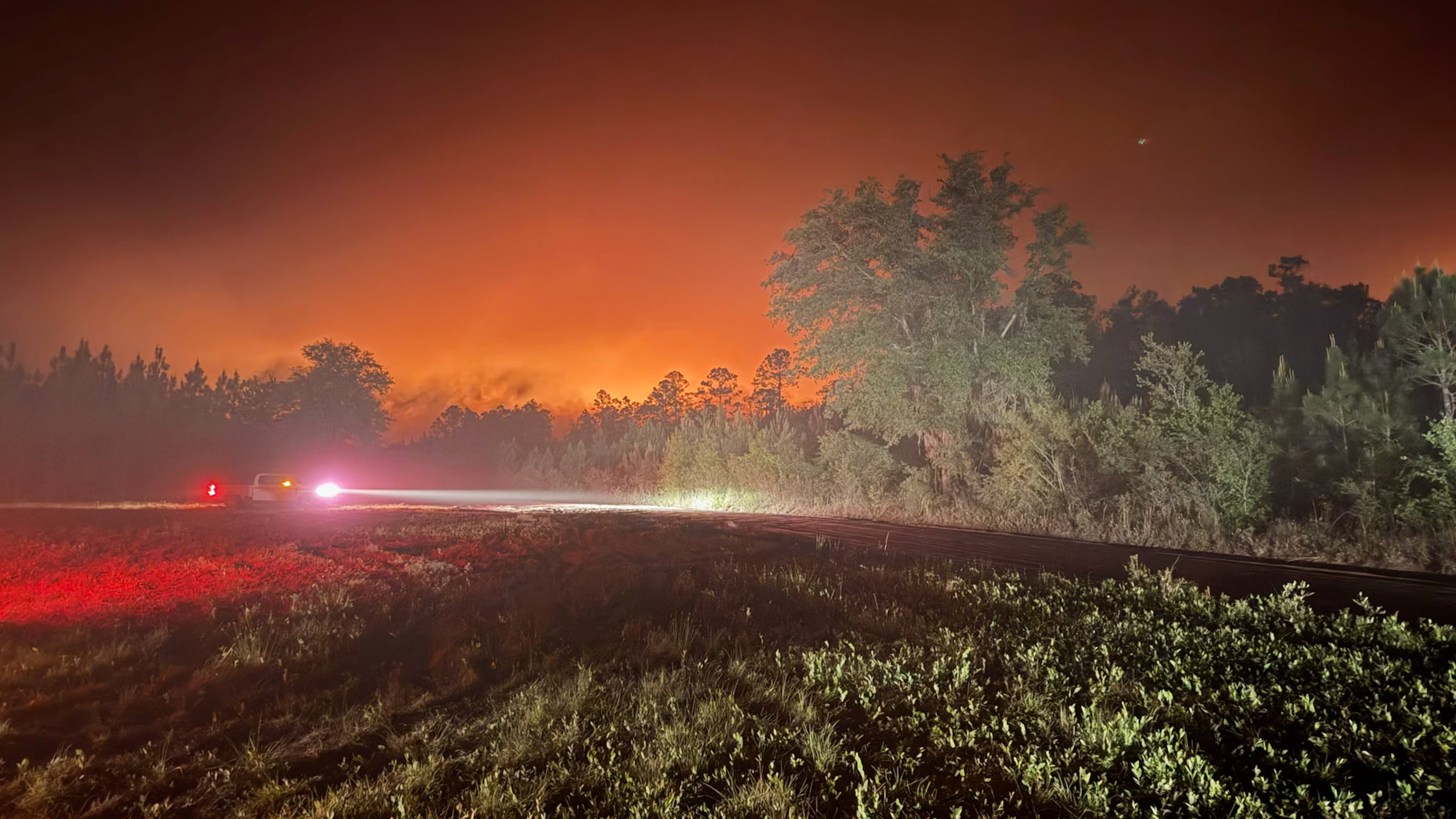 Dramatic night glow from Georgia wildfire — flames illuminating the sky